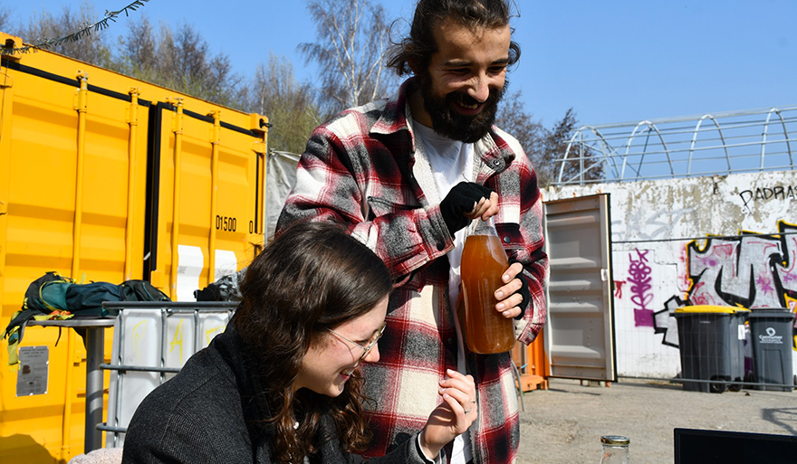 Nicolas, La Maison Co-lead and Margo, one of the two interns, share apple juice