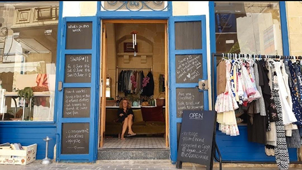 Tonya, owner of VogueX, sitting in her shop